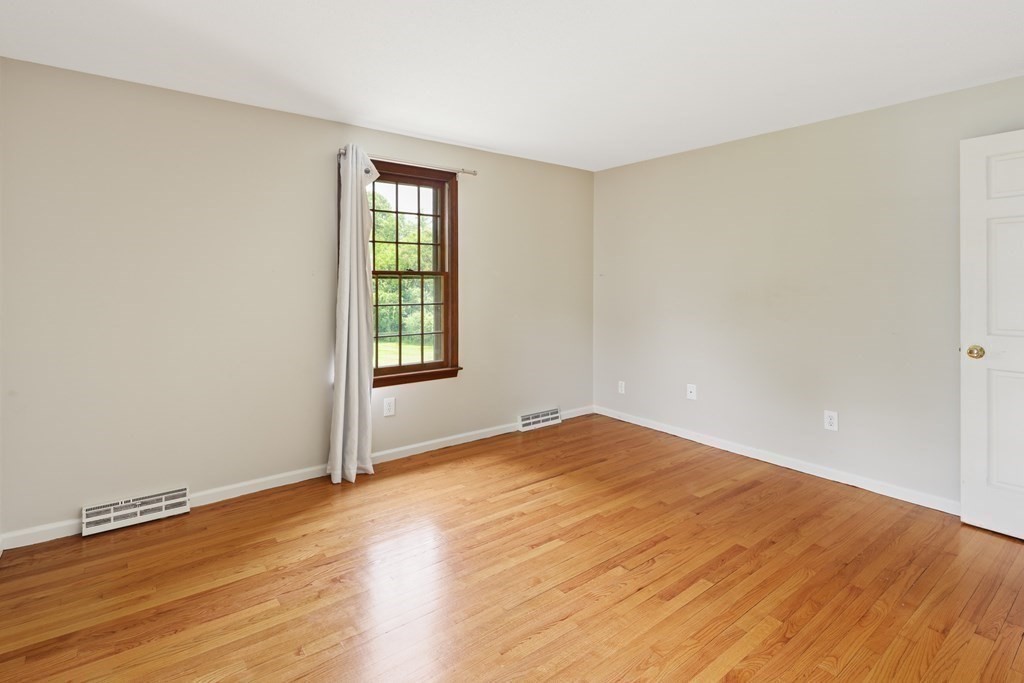 17 Bittersweet Lane Wilbraham, MA 01095 - Photo 32 of 40 a view of an empty room with wooden floor and a window