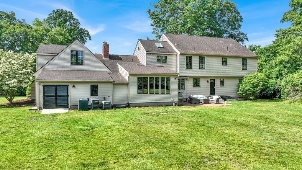 17 Bittersweet Lane Wilbraham, MA 01095 - Photo 5 of 40 a front view of a house with a yard and trees