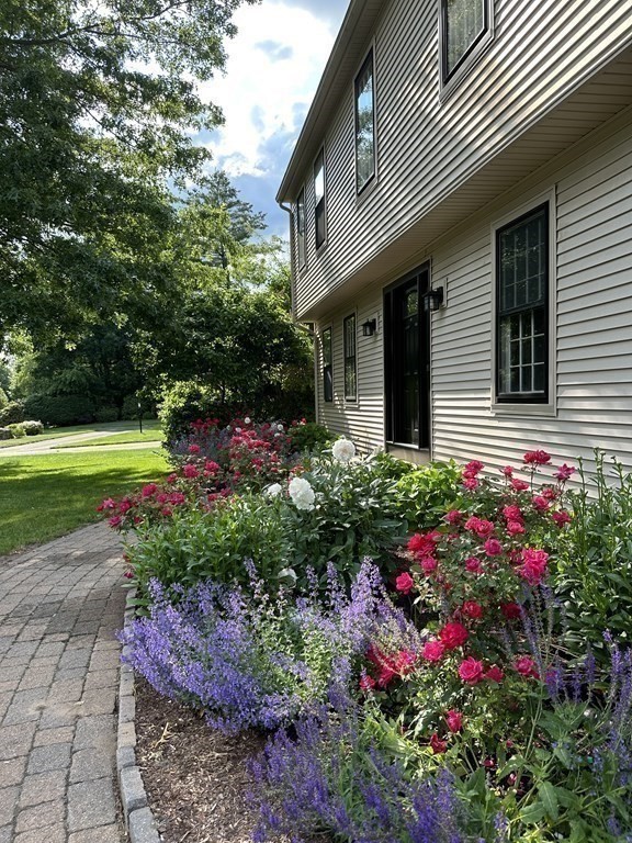 17 Bittersweet Lane Wilbraham, MA 01095 - Photo 9 of 40 a flower garden is sitting in front of a house