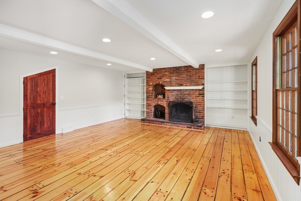 17 Bittersweet Lane Wilbraham, MA 01095 - Photo 10 of 40 a view of empty room with wooden floor and fireplace