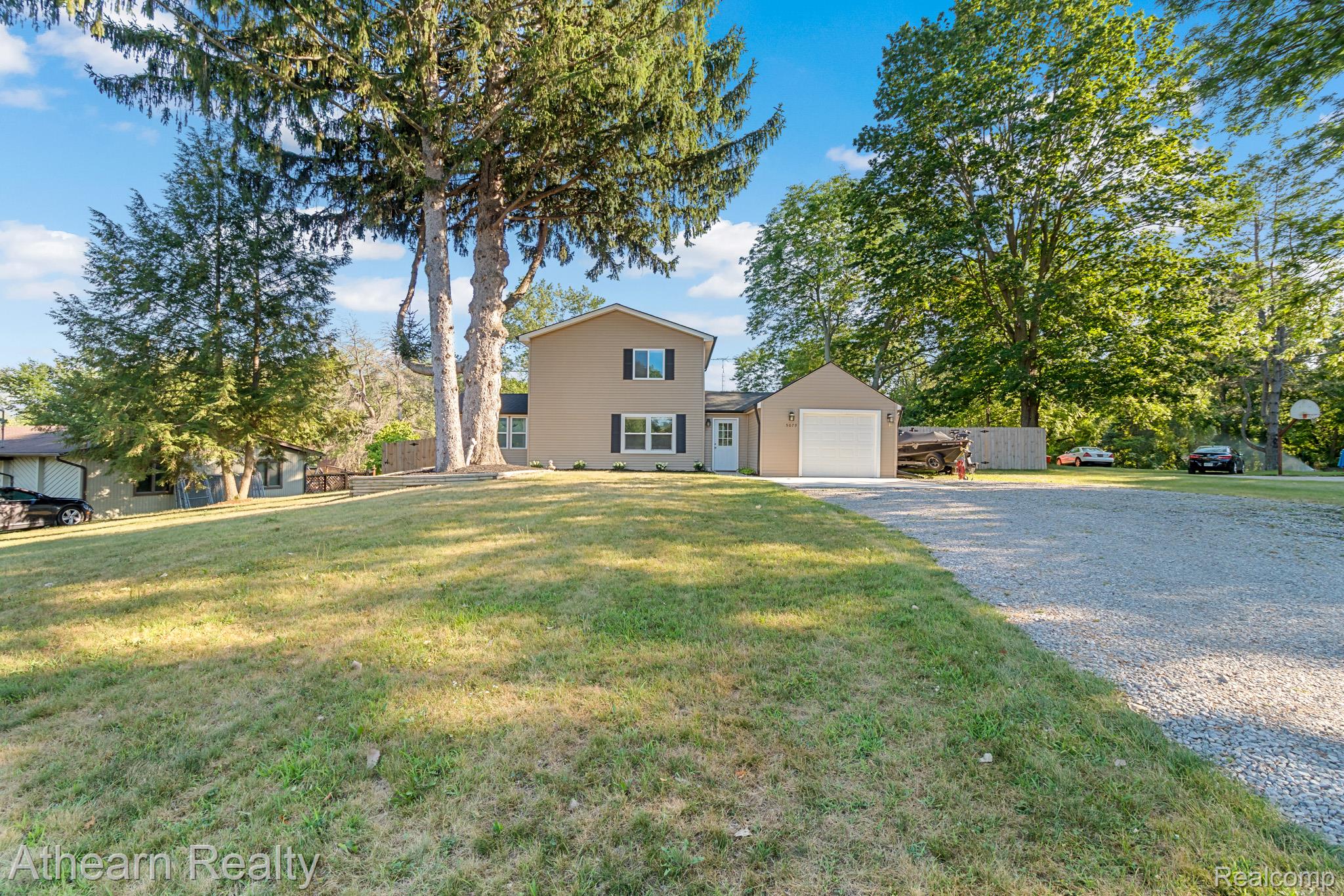 5079 West Thompson Road Linden, MI 48451 - Photo 3 of 27 Two-story colonial home situated on expansive grounds with mature landscaping