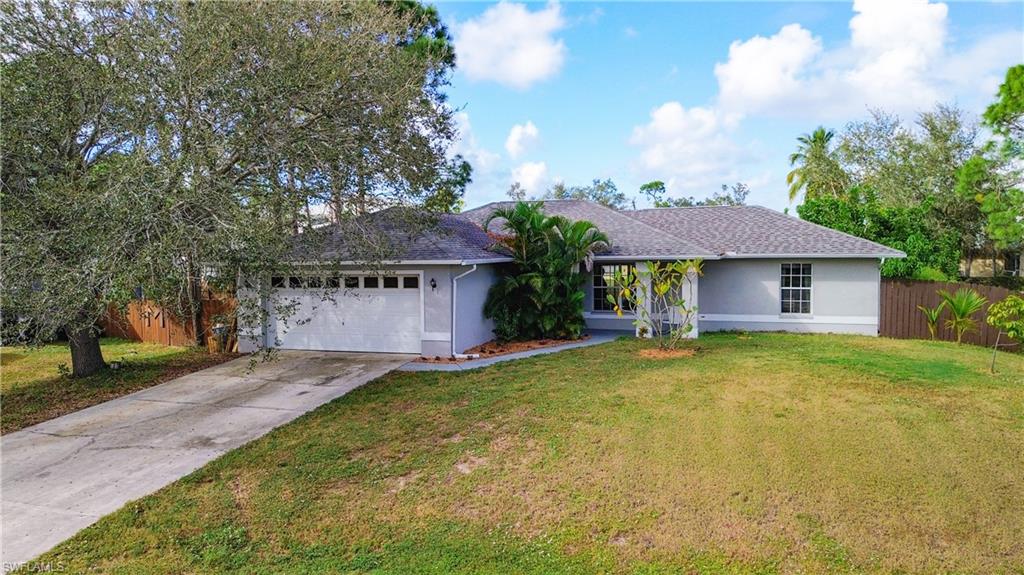 18282 Fern Road Fort Myers, FL 33967 - Photo 3 of 24 a front view of a house with a garden and trees