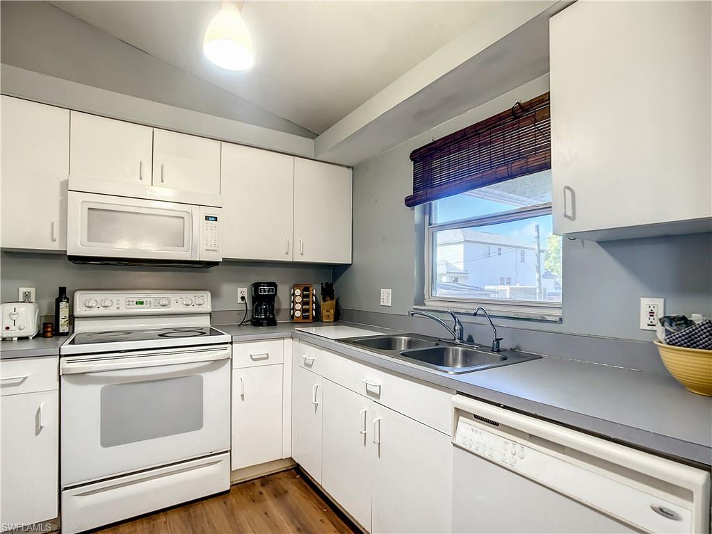 18282 Fern Road Fort Myers, FL 33967 - Photo 8 of 24 a kitchen with stainless steel appliances white cabinets and a sink