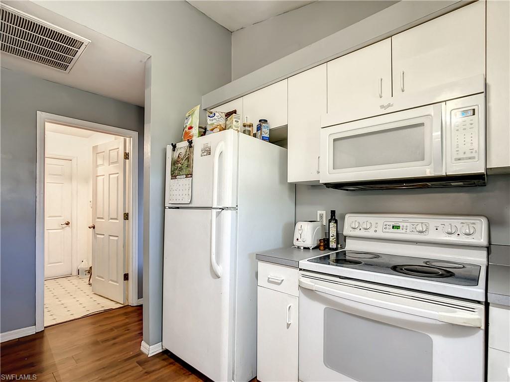 18282 Fern Road Fort Myers, FL 33967 - Photo 9 of 24 a white refrigerator freezer sitting inside of a kitchen