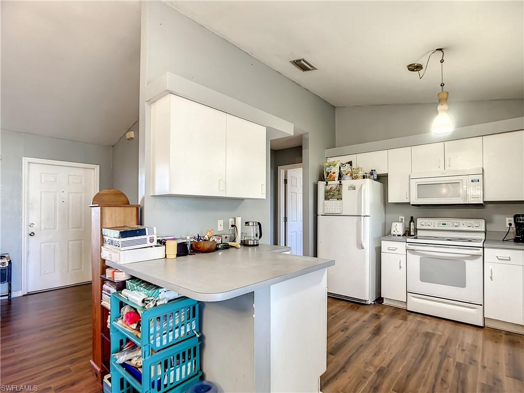 18282 Fern Road Fort Myers, FL 33967 - Photo 10 of 24 a kitchen with stainless steel appliances granite countertop a sink stove and refrigerator
