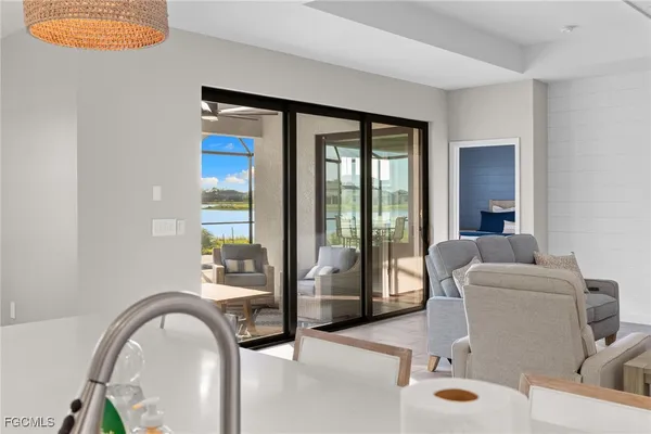 a living room with furniture and a floor to ceiling window