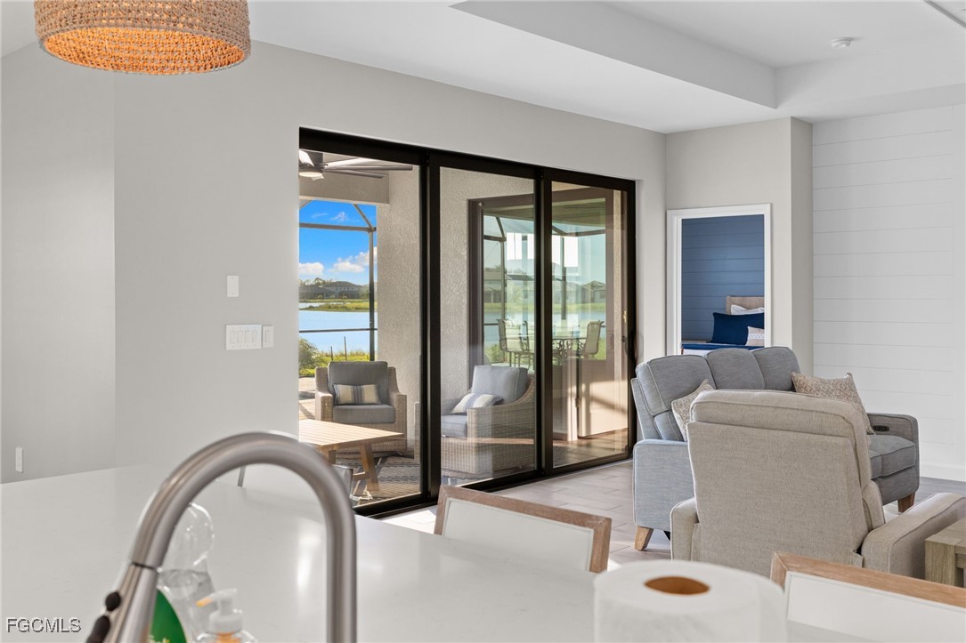 10575 Timber Creek Drive Fort Myers, FL 33913 - Photo 17 of 50 a living room with furniture and a floor to ceiling window