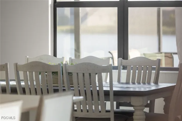a view of a balcony with dining table and chairs
