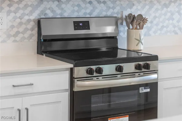 a stove top oven sitting inside of a kitchen