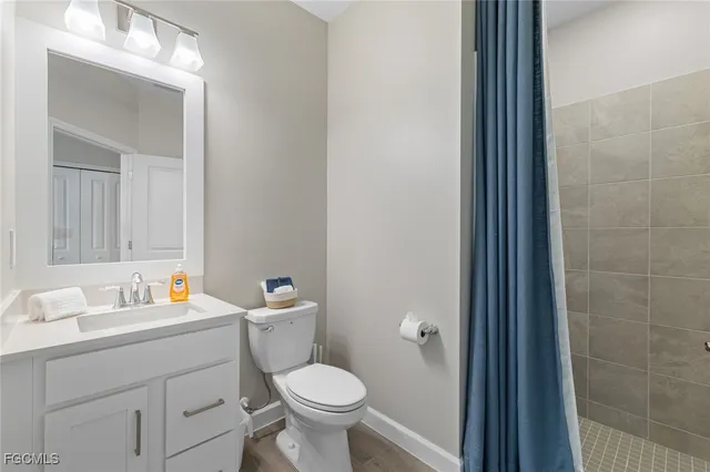 a bathroom with a sink toilet and a mirror