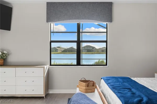a view of a bedroom with furniture and window