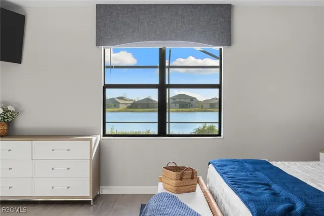 a view of a bedroom with furniture and window