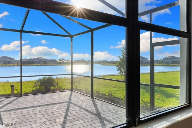 a view of a glass door with a yard from a window