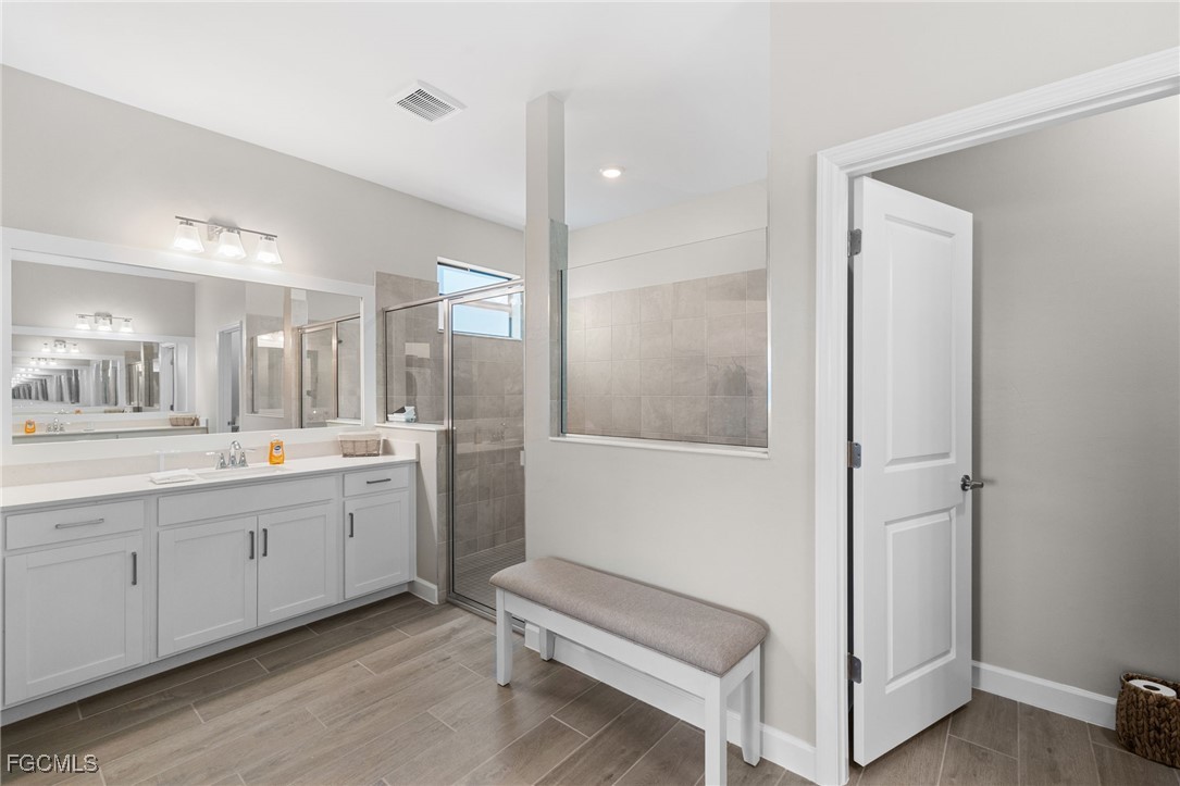 10575 Timber Creek Drive Fort Myers, FL 33913 - Photo 39 of 50 a bathroom with a double vanity sink and mirror