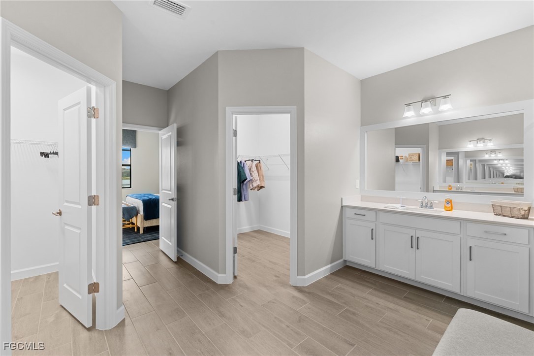 10575 Timber Creek Drive Fort Myers, FL 33913 - Photo 40 of 50 a spacious bathroom with a mirror and a sink