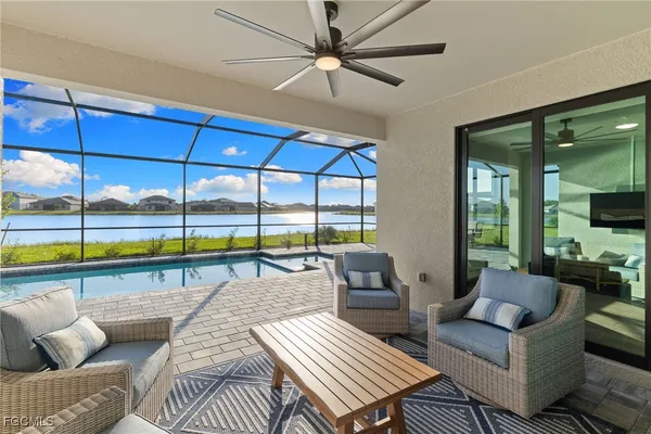 a living room with furniture and a floor to ceiling window