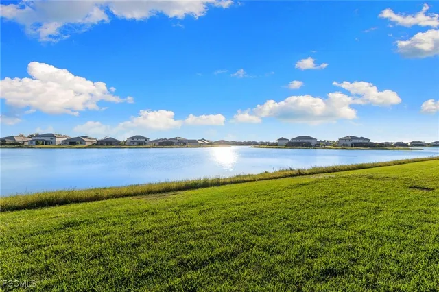 a view of a lake with houses in the back