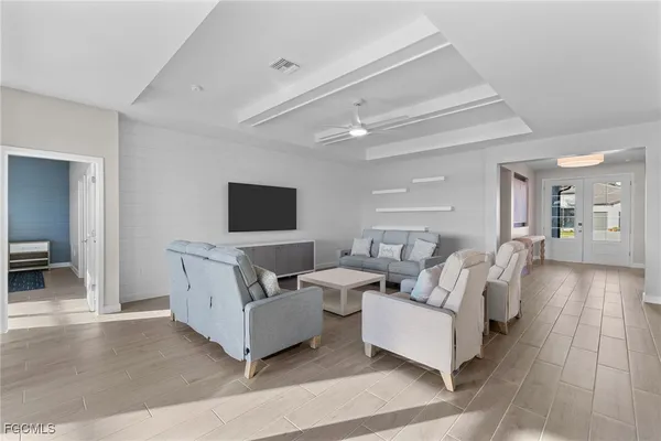 a living room with couches and a flat screen tv