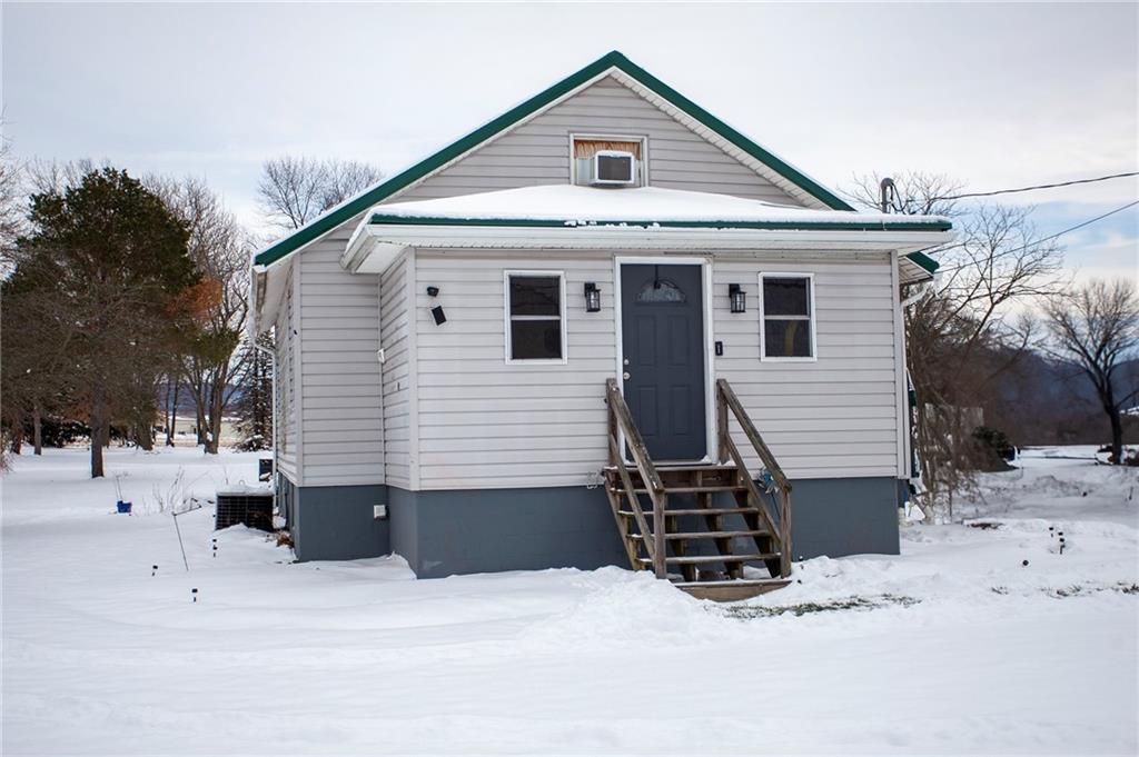 a view of a house with snow on the road