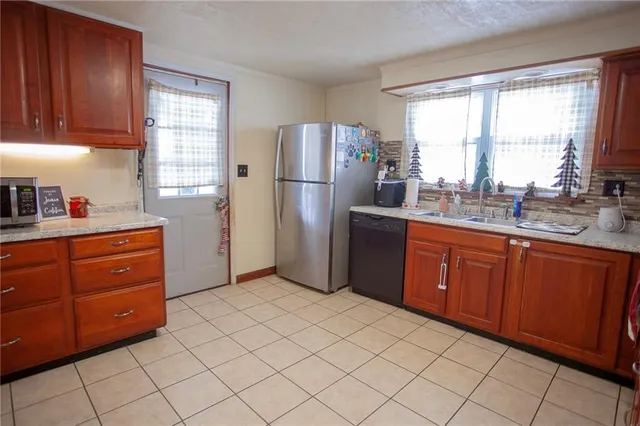 a kitchen with stainless steel appliances granite countertop a refrigerator and sink