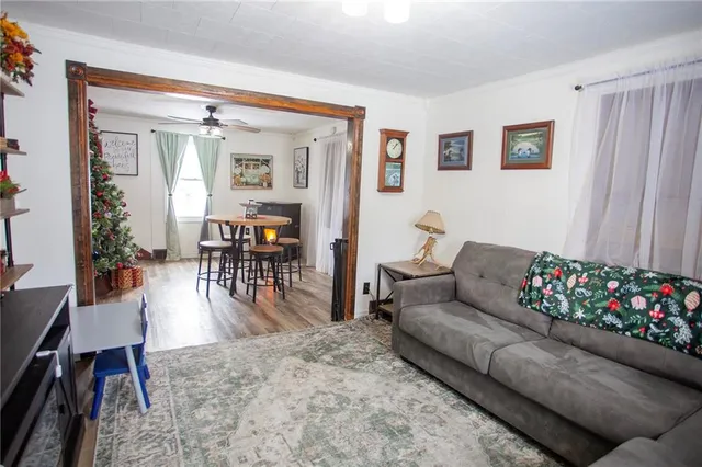 a living room with furniture and wooden floors