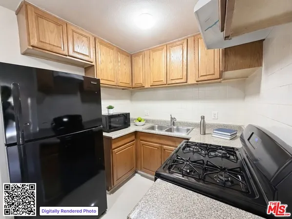 a kitchen with stainless steel appliances granite countertop a sink stove top oven and cabinets