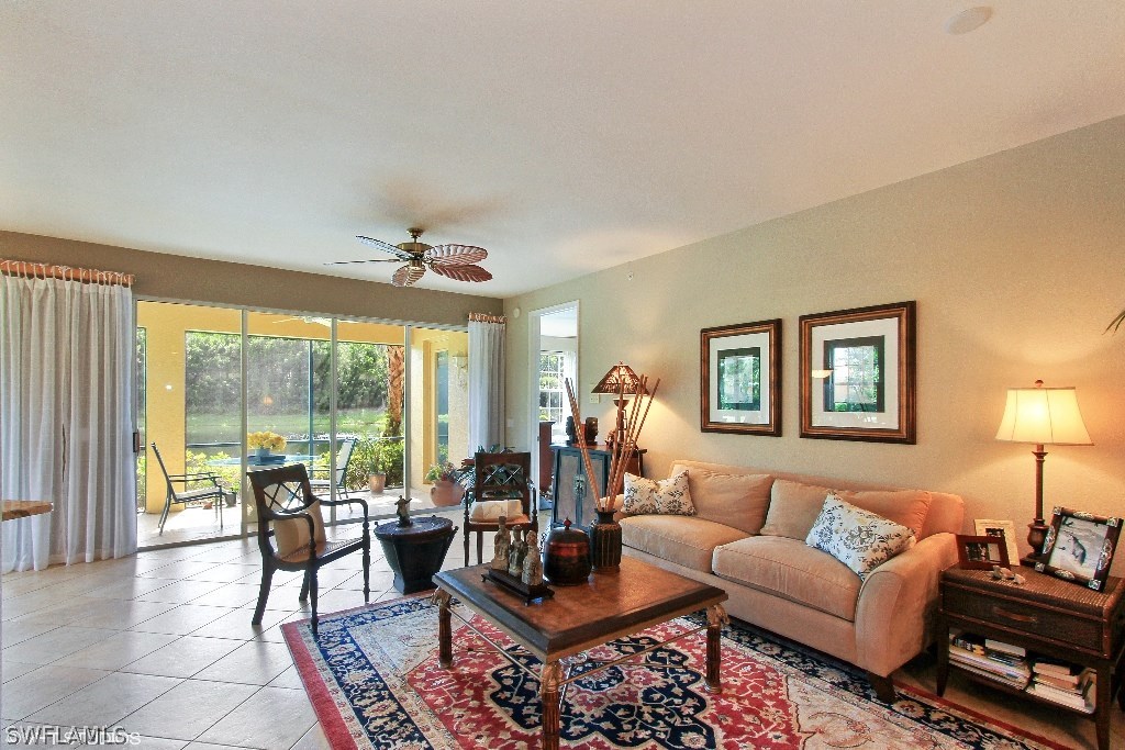 10110 Valiant Court, Unit 101 Fort Myers, FL 33913 - Photo 2 of 25 a living room with furniture and a large window