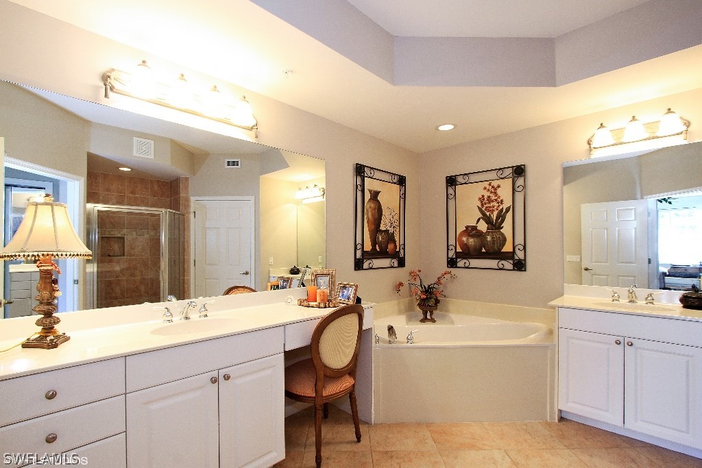10110 Valiant Court, Unit 101 Fort Myers, FL 33913 - Photo 7 of 25 a bathroom with a double vanity sink mirror and bathtub