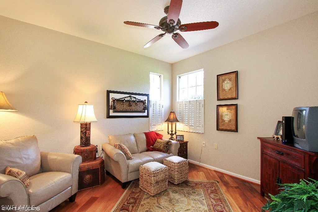 10110 Valiant Court, Unit 101 Fort Myers, FL 33913 - Photo 8 of 25 a living room with furniture and a flat screen tv