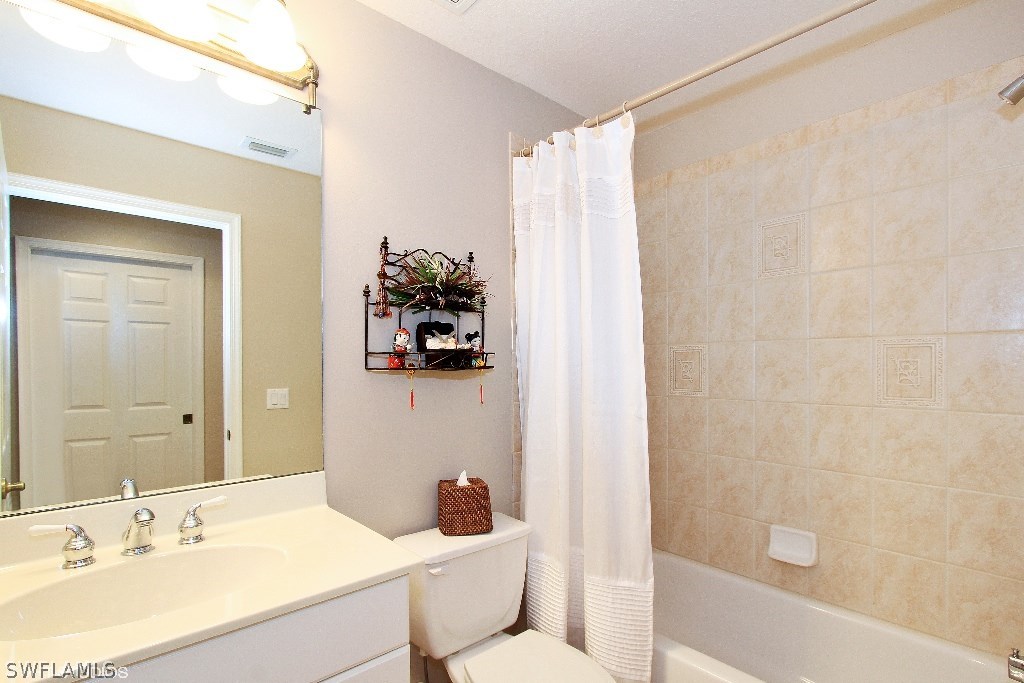 10110 Valiant Court, Unit 101 Fort Myers, FL 33913 - Photo 10 of 25 a bathroom with a sink toilet and shower