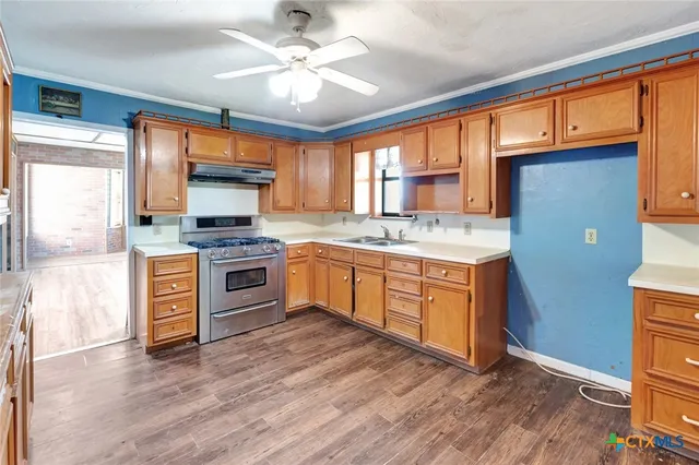 a kitchen with a stove a sink and a microwave