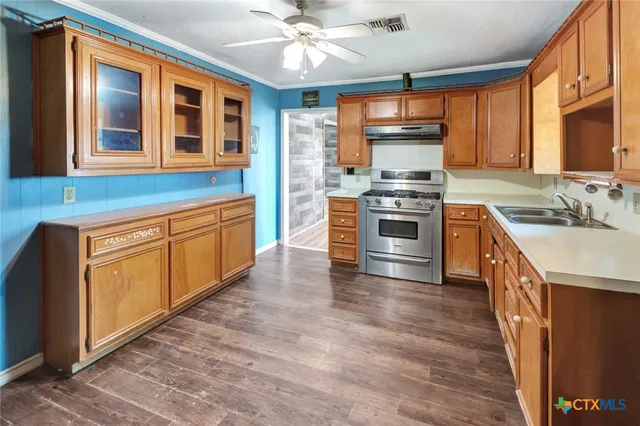 a kitchen with stainless steel appliances granite countertop a stove and a sink