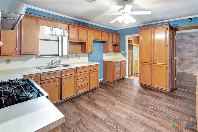 a kitchen with stainless steel appliances a stove a sink and a refrigerator