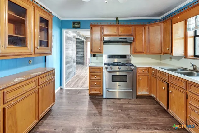 a kitchen with stainless steel appliances granite countertop a stove and a sink