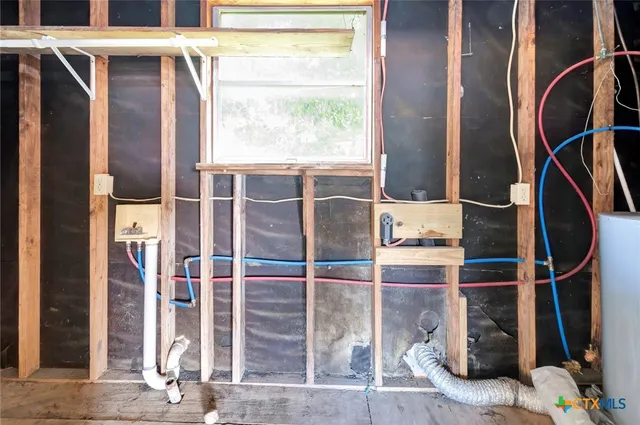 a room with wooden floor and windows
