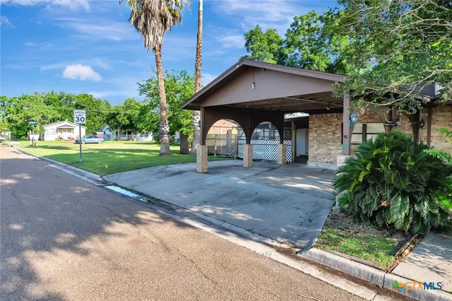 a view of a wooden house with a yard