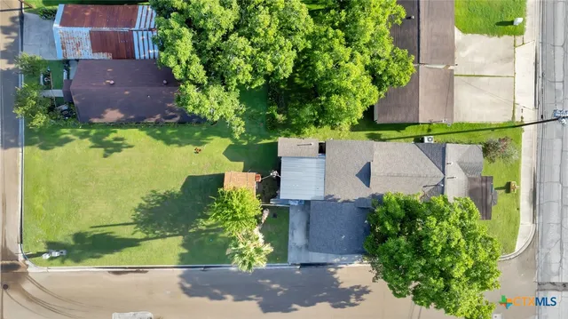 an aerial view of a house with a garden and plants
