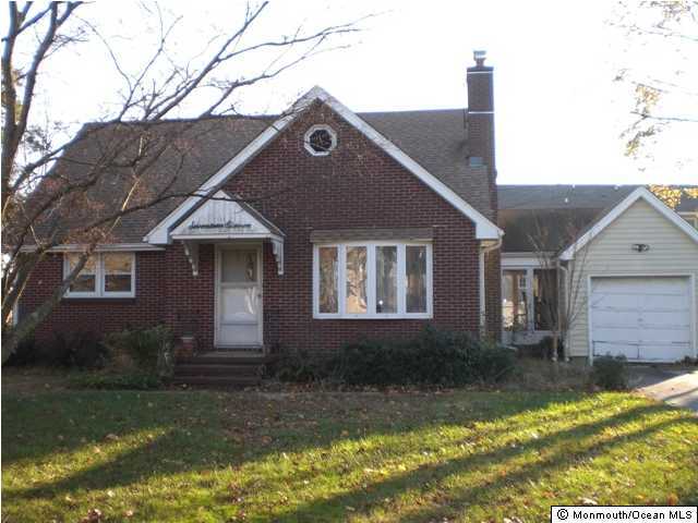 1711 Marconi Road Wall, NJ 07719 - Photo 1 of 3 a front view of a house with a yard