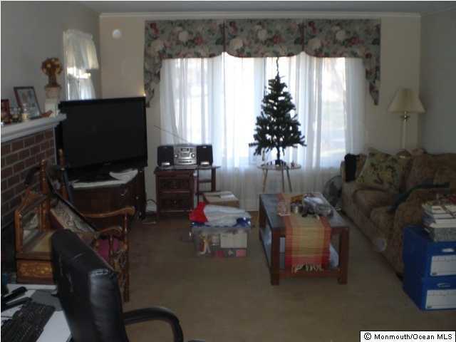 1711 Marconi Road Wall, NJ 07719 - Photo 2 of 3 a living room with furniture and a flat screen tv
