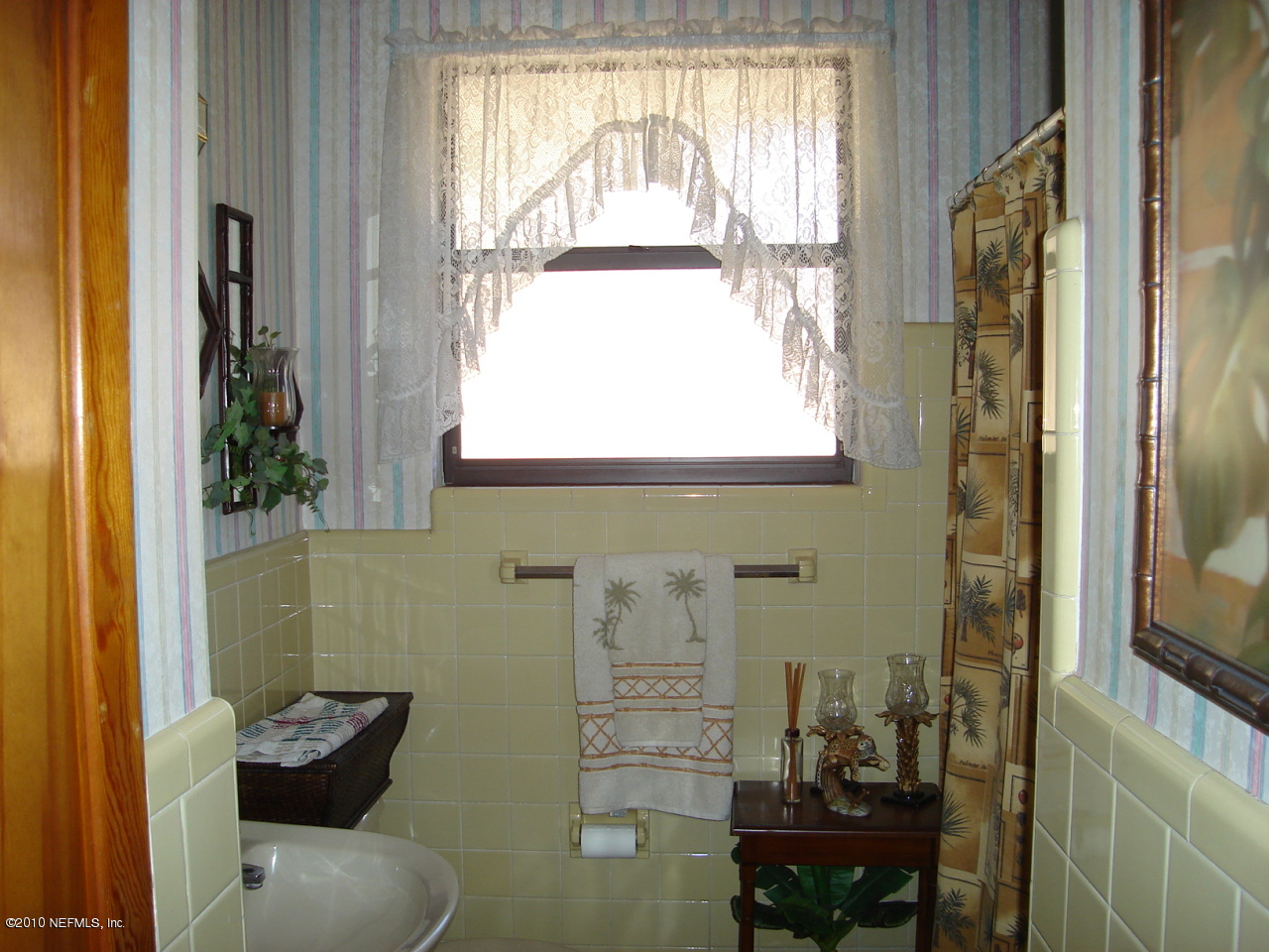2586 Broward Road Jacksonville, FL 32218 - Photo 7 of 10 a bathroom with a window and a mirror