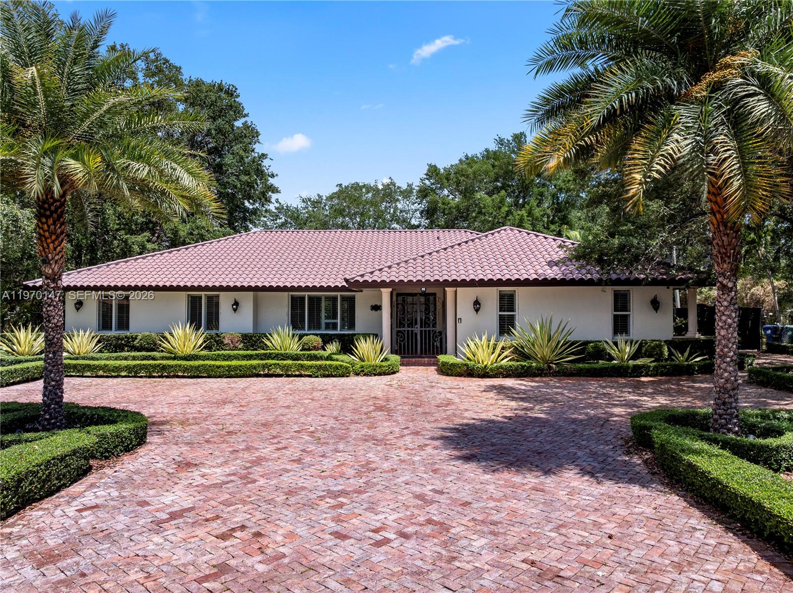 8801 Southwest 124th Street Miami, FL 33176 - Photo 1 of 48 a front view of a house with a garden