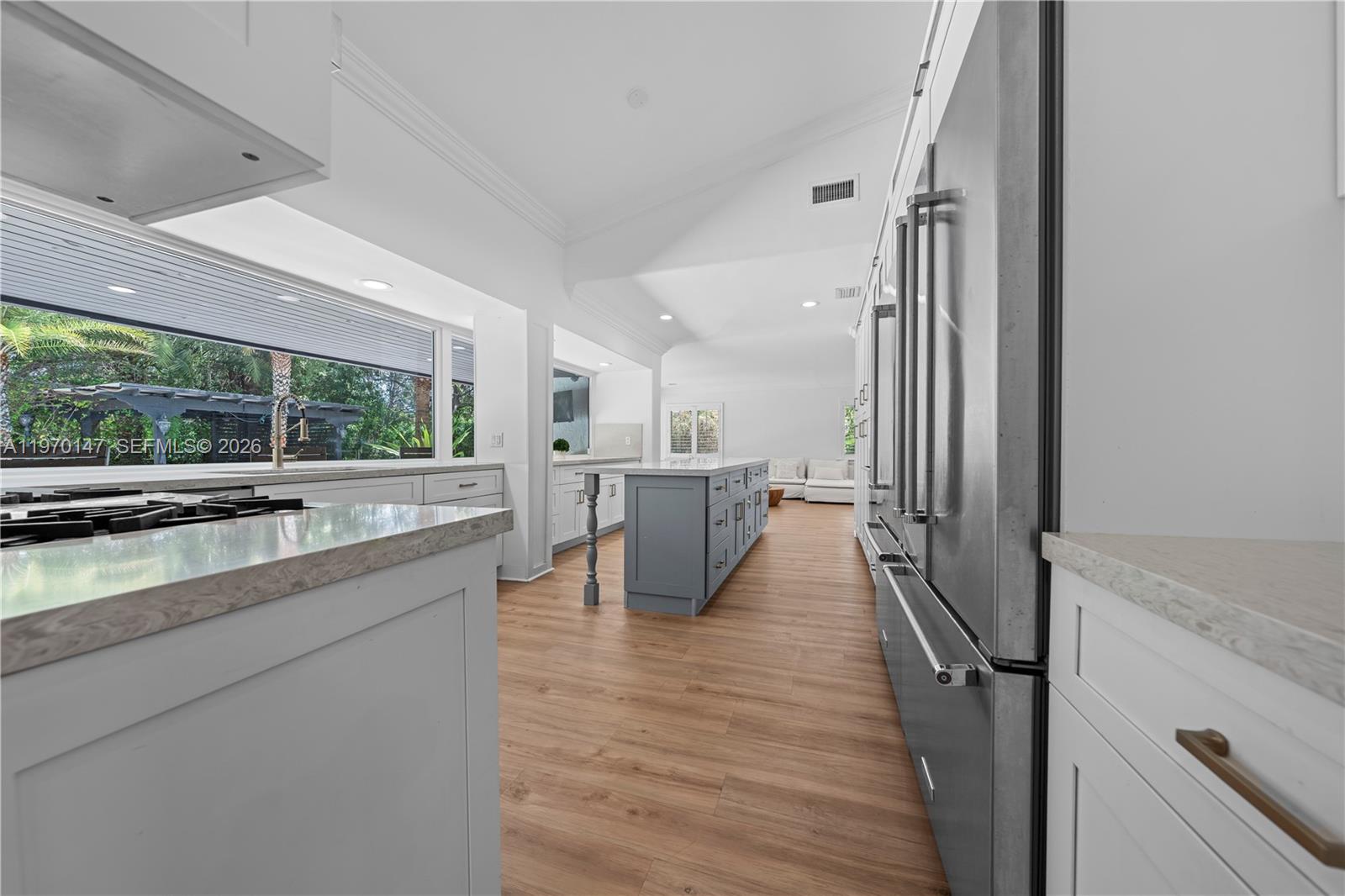 8801 Southwest 124th Street Miami, FL 33176 - Photo 11 of 48 a kitchen with stainless steel appliances a large counter top a stove and a wooden floors