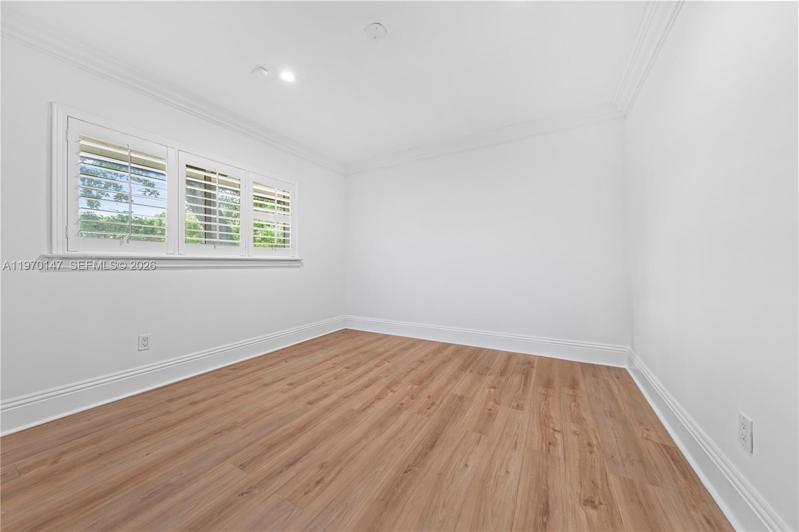 8801 Southwest 124th Street Miami, FL 33176 - Photo 15 of 48 an empty room with wooden floor and windows
