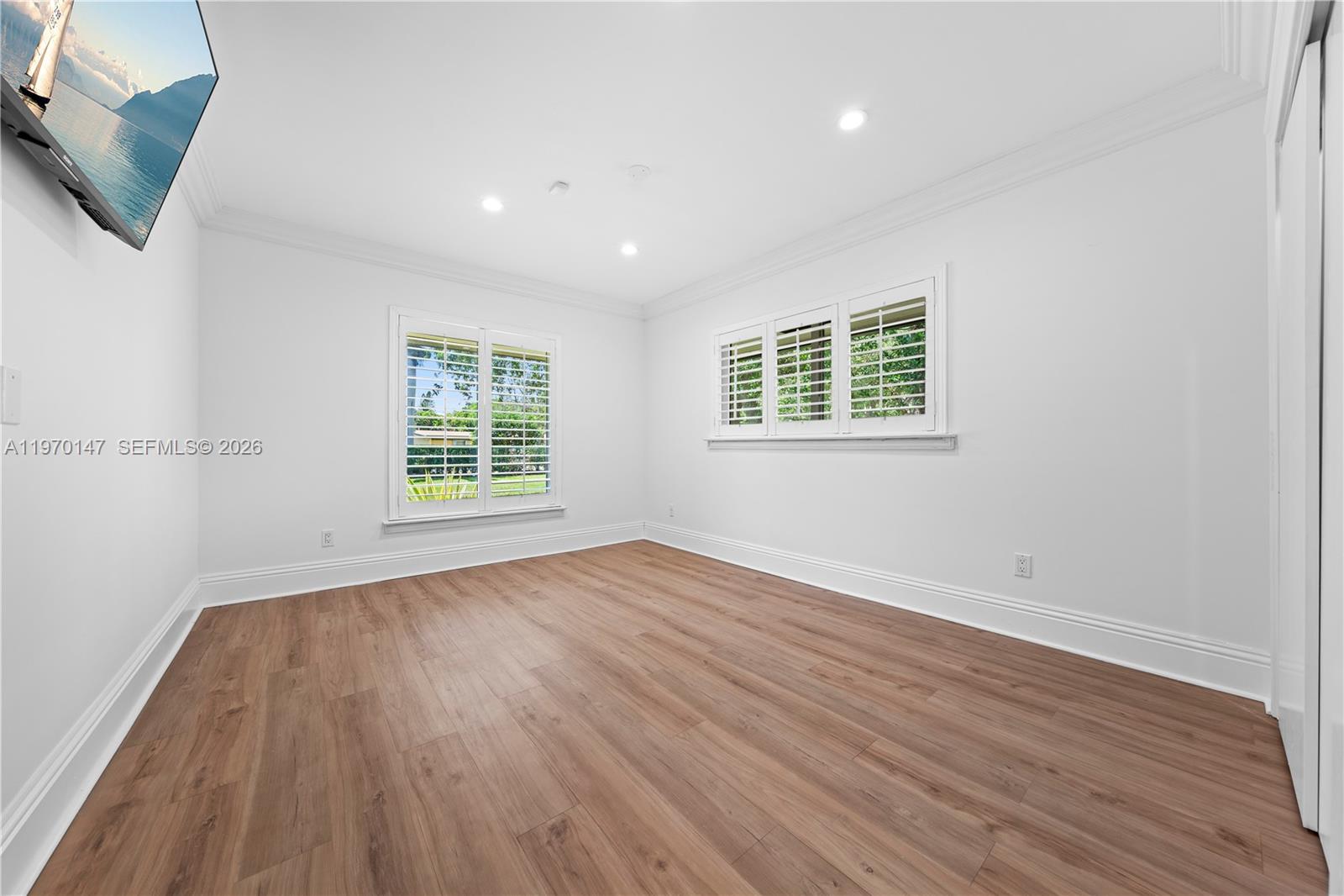 8801 Southwest 124th Street Miami, FL 33176 - Photo 17 of 48 an empty room with wooden floor and windows