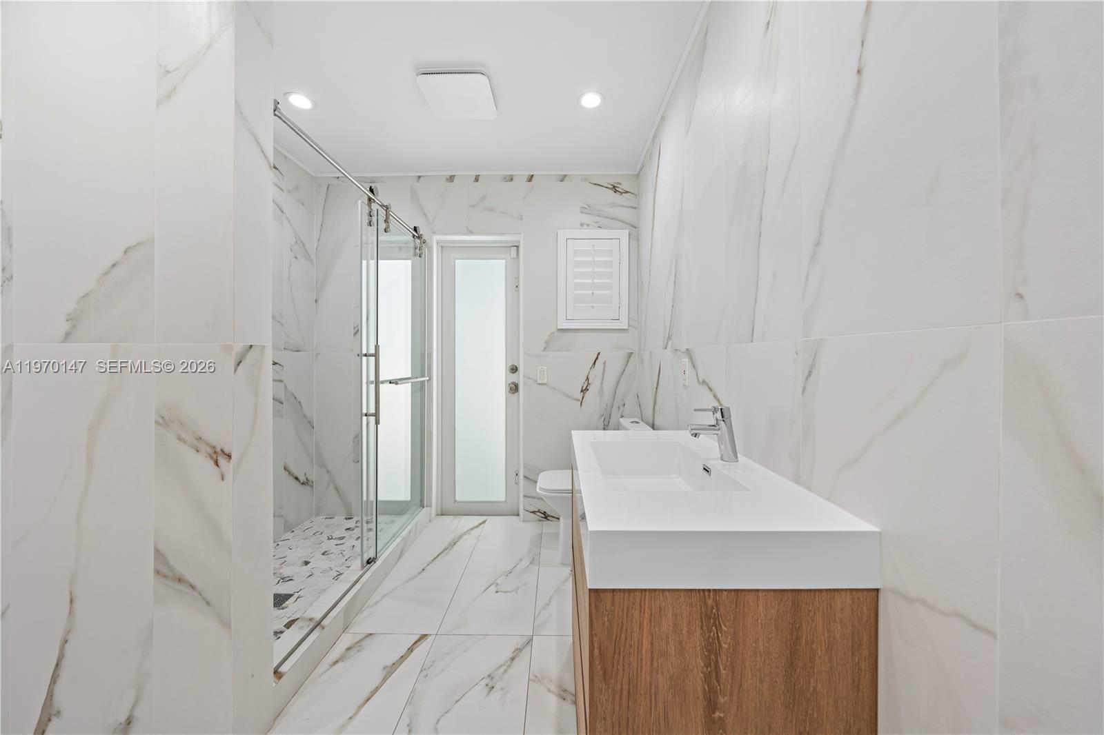 8801 Southwest 124th Street Miami, FL 33176 - Photo 19 of 48 a bathroom with a sink a shower and a mirror