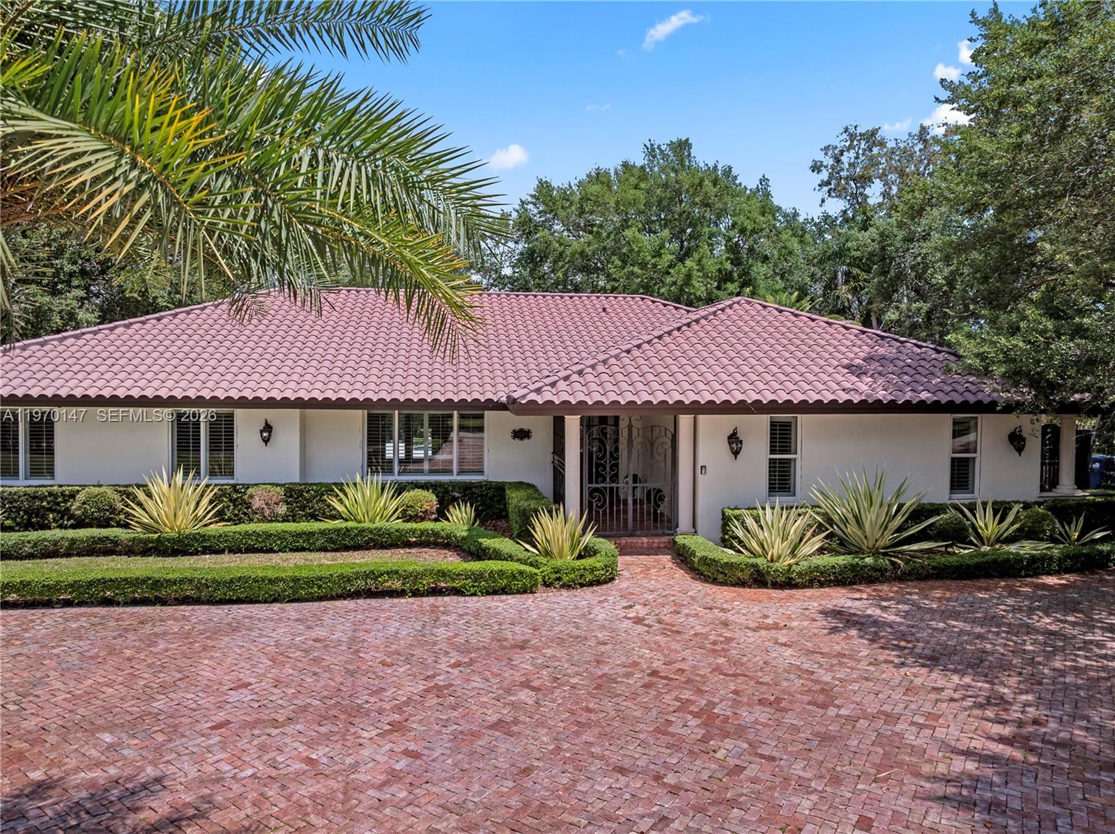 8801 Southwest 124th Street Miami, FL 33176 - Photo 2 of 48 a front view of a house with a garden