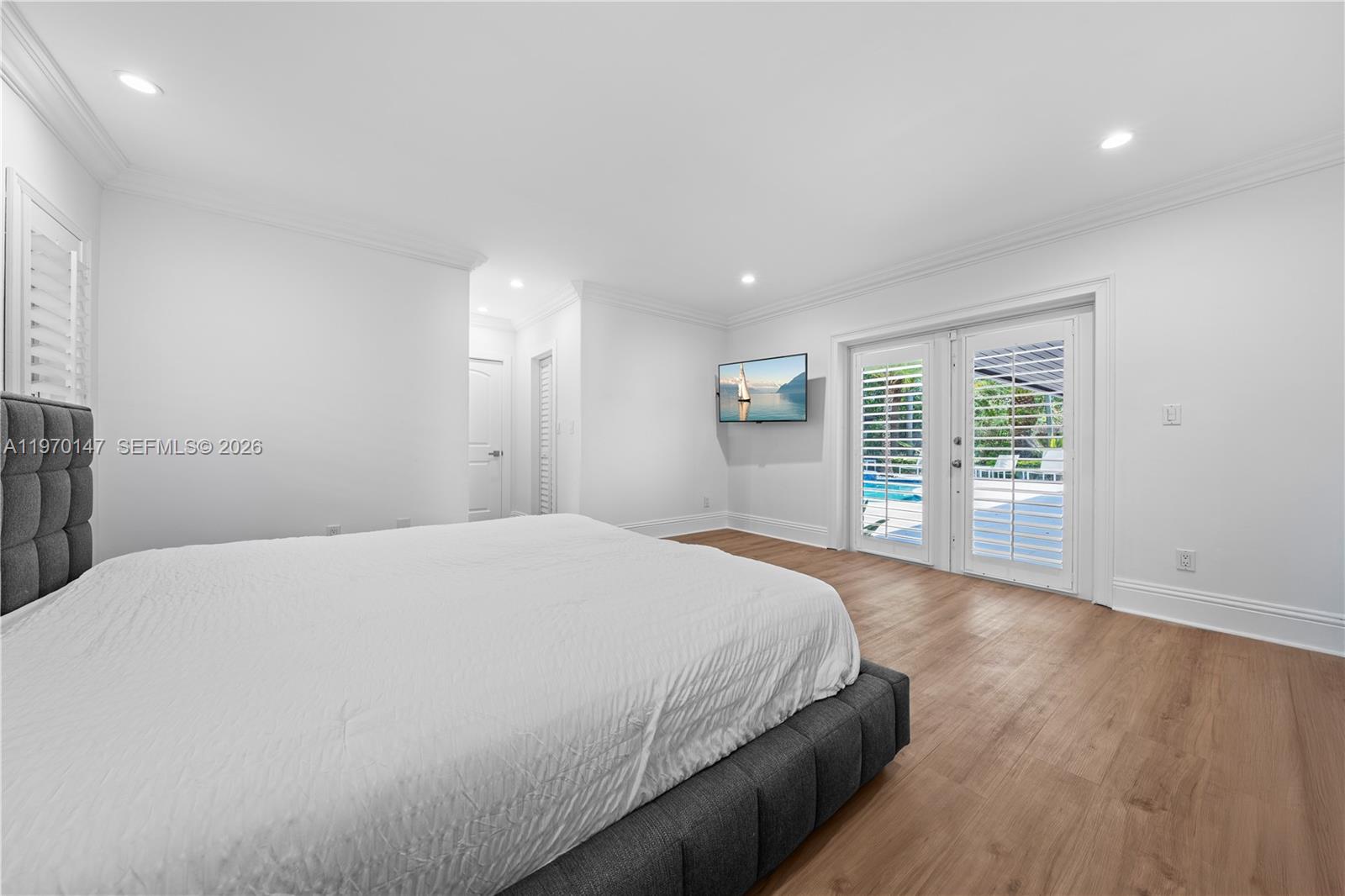 8801 Southwest 124th Street Miami, FL 33176 - Photo 22 of 48 a spacious bedroom with a large bed and wooden floor