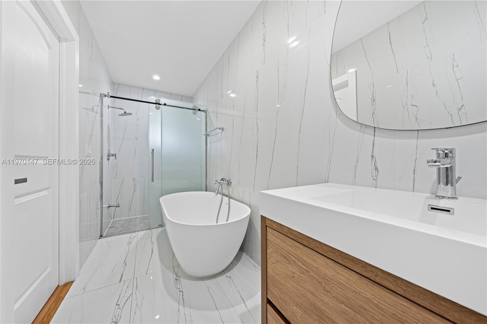 8801 Southwest 124th Street Miami, FL 33176 - Photo 26 of 48 a spacious bathroom with a sink a mirror a bathtub and shower