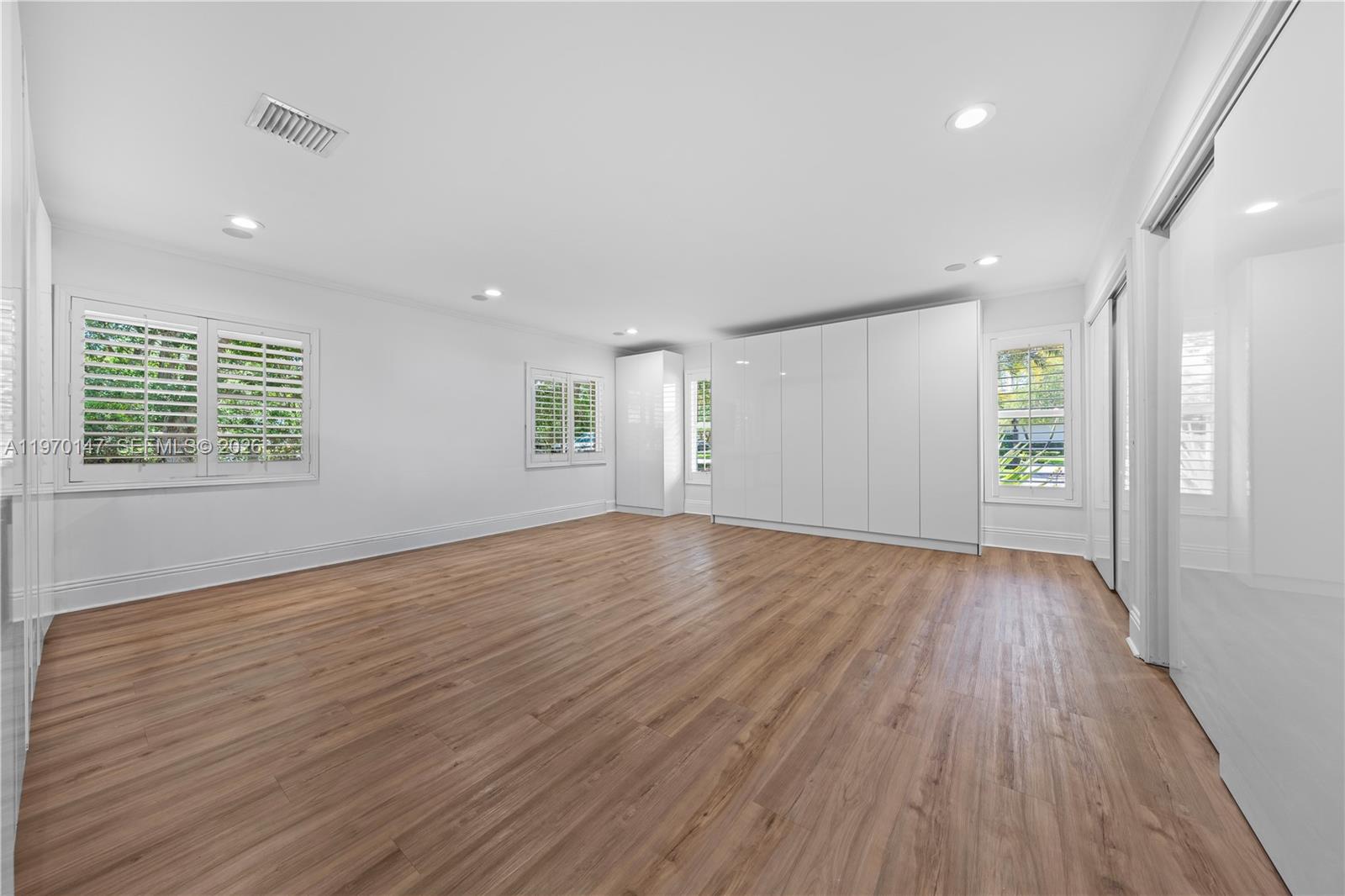 8801 Southwest 124th Street Miami, FL 33176 - Photo 28 of 48 an empty room with wooden floor and windows