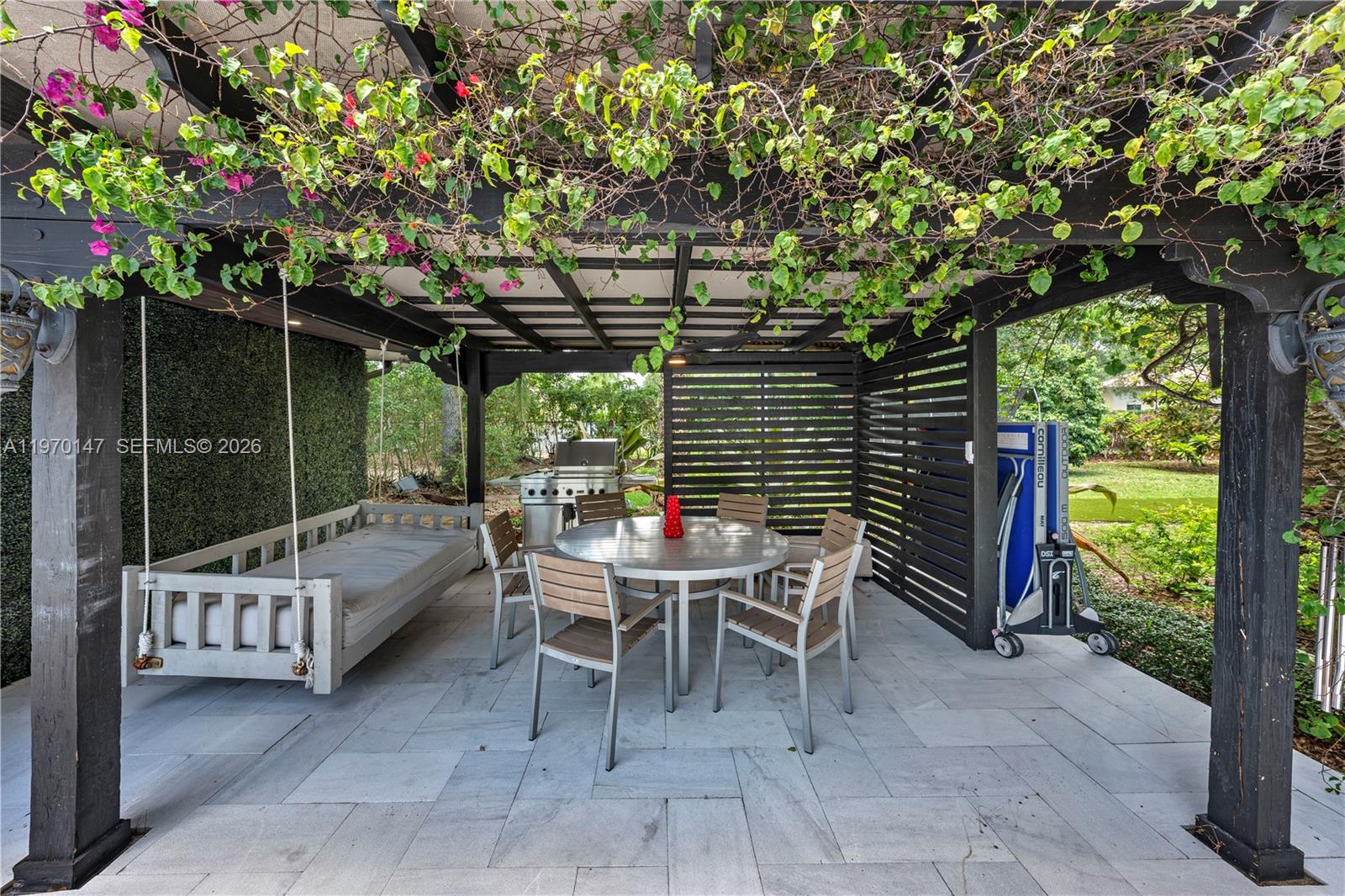 8801 Southwest 124th Street Miami, FL 33176 - Photo 40 of 48 a view of a chairs and table in backyard of the house